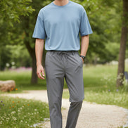 Gray pants worn by a person on a white background