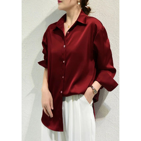 Burgundy satin blouse worn by a model, shown from the side