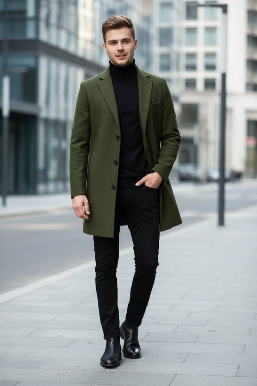 Green coat on a mannequin against a gray background