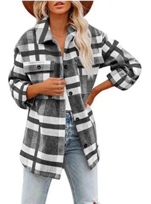 Woman wearing a gray and white plaid shirt with jeans, against a white background.