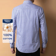 Blue and white checkered shirt worn by a person on a beige background with a 100% cotton label.