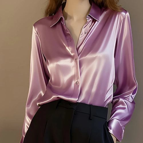Pink satin button-down shirt worn by a model with black pants.
