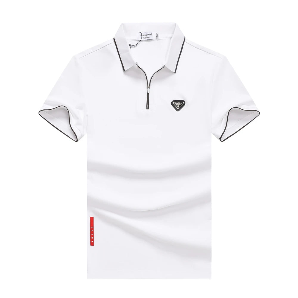 A white short-sleeve polo shirt with a half-zip collar, black piping trim on the collar and sleeve cuffs, a small black triangular logo on the left chest, and a small red vertical tag near the lower left hem, shown on a plain white background.