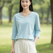 Light blue top worn by a model on a plain background