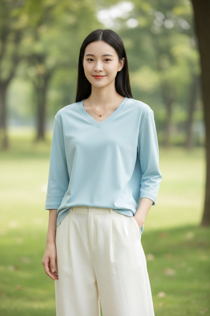 Light blue top worn by a model on a plain background