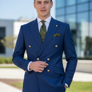 Blue suit jacket with gold buttons and matching pants on a white background