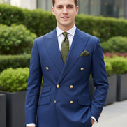 Blue suit jacket with gold buttons and matching pants on a white background