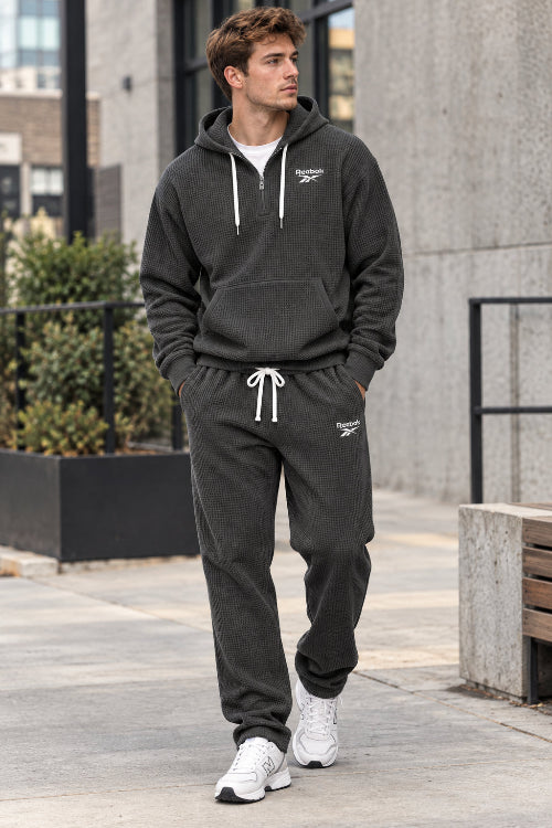 Gray hoodie and pants set with Lacoste logo on a white background