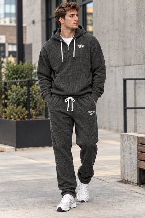 Gray hoodie and pants set with Lacoste logo on a white background
