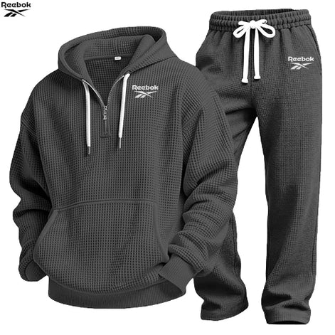 Gray hoodie and pants set with Lacoste logo on a white background