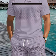 A man wearing a light lavender short-sleeve t-shirt and matching patterned shorts, standing on a wooden boardwalk 