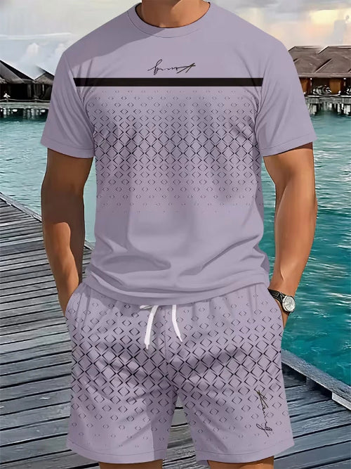 A man wearing a light lavender short-sleeve t-shirt and matching patterned shorts, standing on a wooden boardwalk 