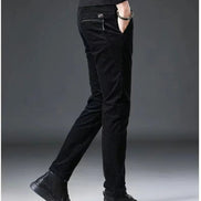 Person wearing black pants on a gray background