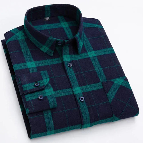 A folded long-sleeve button-up shirt with a dark navy and green plaid pattern, featuring a classic collar and a chest pocket with buttoned cuffs.