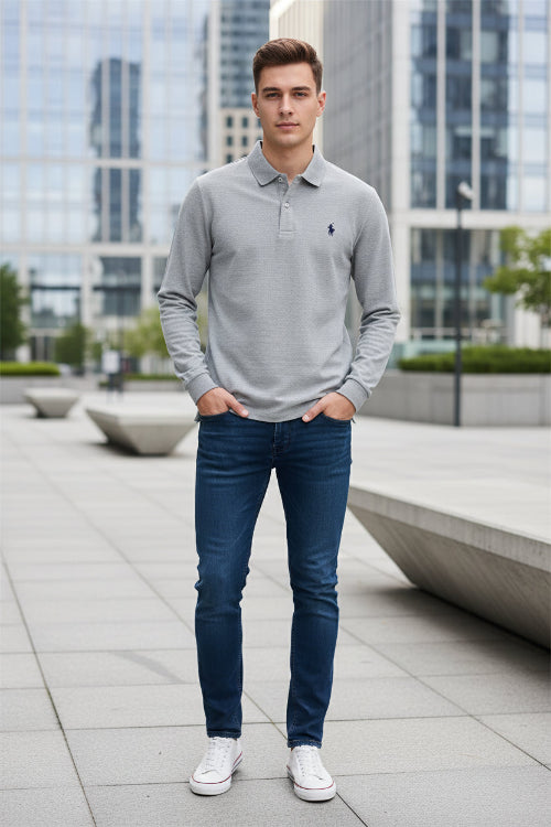 Gray polo shirt with Ralph Lauren logo held by a hand, with more shirts in the background.