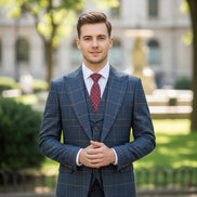 Blue checkered suit on a mannequin with a red tie against a brown curtain background