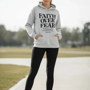 Gray hoodie with 'Faith Over Fear' text on a light background