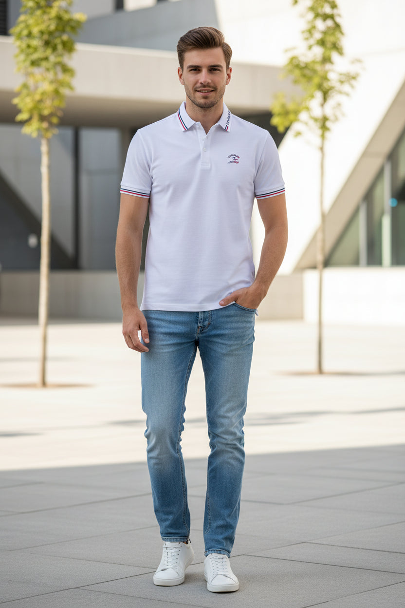 White short-sleeve polo shirt with red and navy blue striped trim on the collar and sleeve cuffs, featuring a small embroidered logo on the left chest and 'TACE&SHARK' text on the collar. A larger TACE&SHARK logo graphic is visible in the top-left corner.