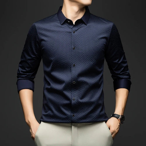 Navy blue patterned shirt worn by a person on a dark background