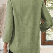 Green jacket worn by a person, with a neutral background