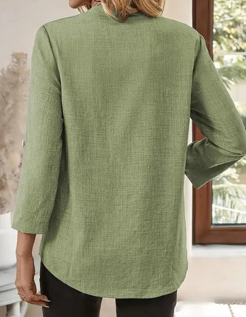 Green jacket worn by a person, with a neutral background