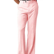 A person wearing light pink wide-leg trousers with a black and white patterned top and black sandals, shown from the waist down on a plain white background.