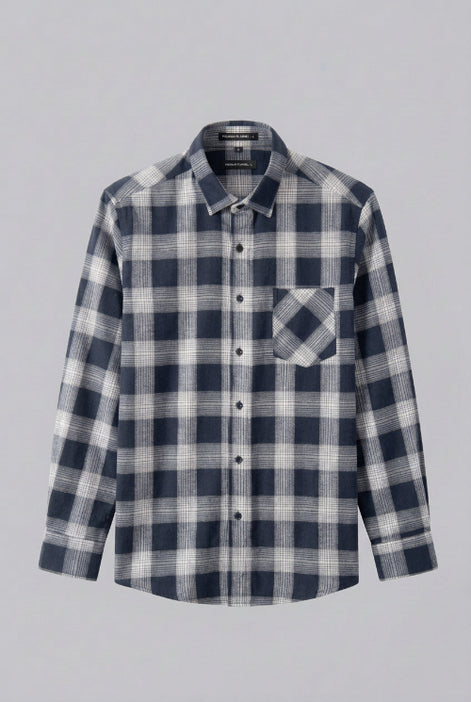 Plaid shirt on a hanger against a white background