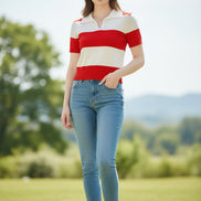 A woman wearing a short-sleeve knit polo shirt with bold horizontal red and off-white stripes, seated indoors against a dark brown leather surface.