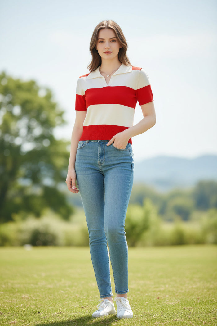 A woman wearing a short-sleeve knit polo shirt with bold horizontal red and off-white stripes, seated indoors against a dark brown leather surface.