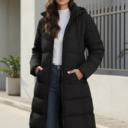 Woman wearing a black puffer coat in an urban setting