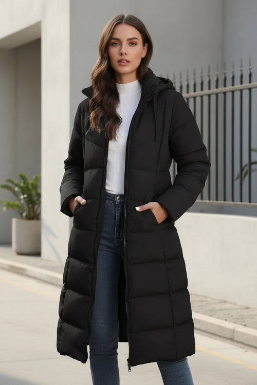 Woman wearing a black puffer coat in an urban setting