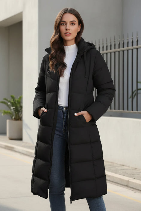 Woman wearing a black puffer coat in an urban setting
