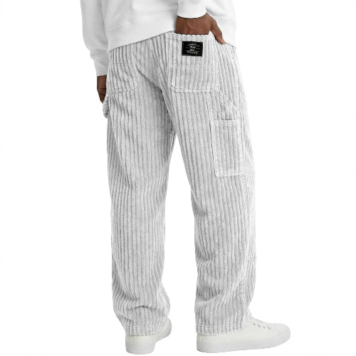 Striped pants worn by a person on a white background