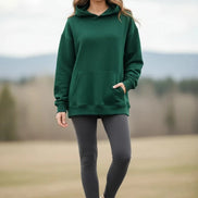 Green hoodie worn by a person on a white background