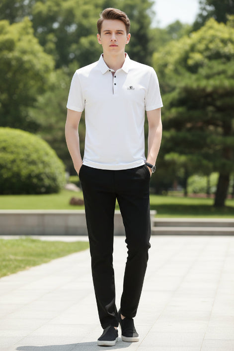 White polo shirt with a brand logo on a gray background