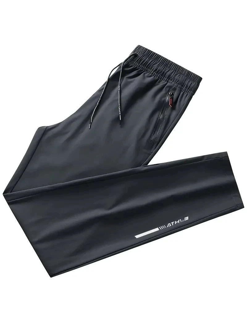 Black athletic pants with drawstring on a white background