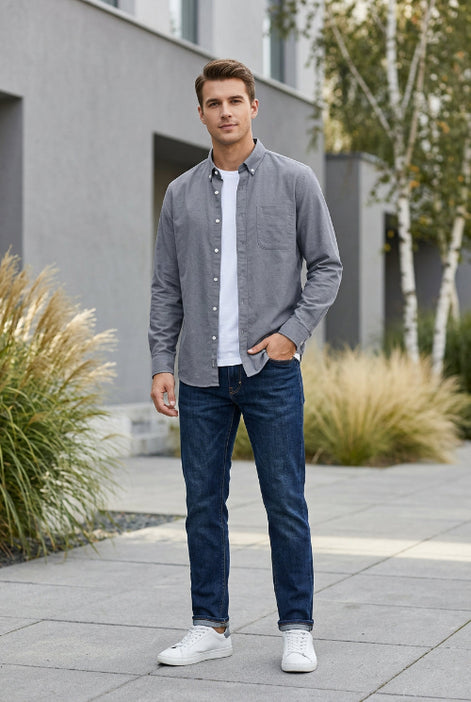 Gray button-up shirt on a hanger against a gray geometric background