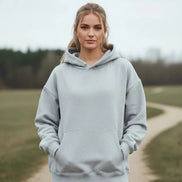Gray hoodie worn by a person on a white background