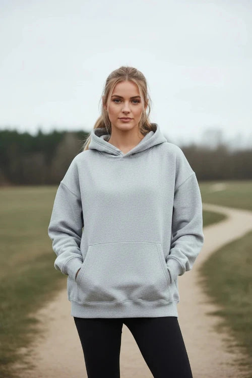 Gray hoodie worn by a person on a white background