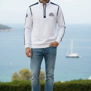 A white long-sleeve quarter-zip pullover sweatshirt with navy blue shoulder panels and sleeve stripes, featuring a 'CUP&SHAW' logo on the left chest 