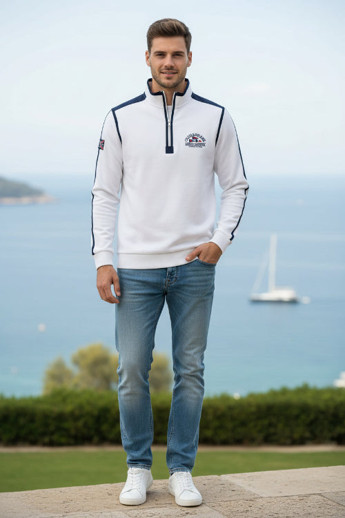A white long-sleeve quarter-zip pullover sweatshirt with navy blue shoulder panels and sleeve stripes, featuring a 'CUP&SHAW' logo on the left chest 