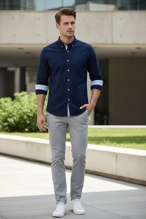 Black dress shirt with white buttons on a white background