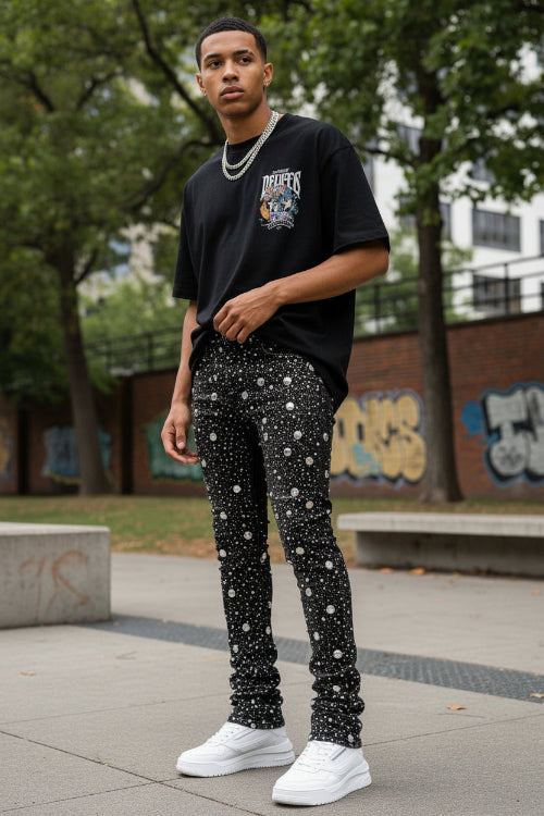 Black distressed jeans on a white background