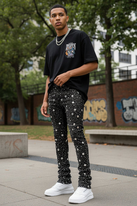Black distressed jeans on a white background