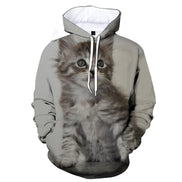 A light gray pullover hoodie featuring a large, realistic 3D-printed graphic of a fluffy gray tabby kitten on the front, with white drawstrings and a white hood lining.