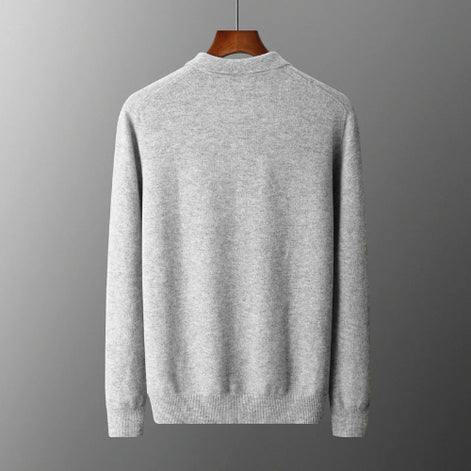 Gray sweater on a hanger against a gray background