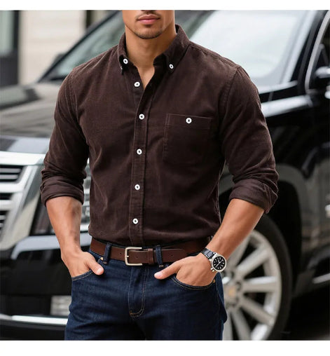 A man wearing a dark brown long-sleeve button-down shirt with rolled-up sleeves, 