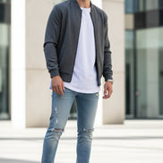 White sneakers with a brand logo on a stone surface