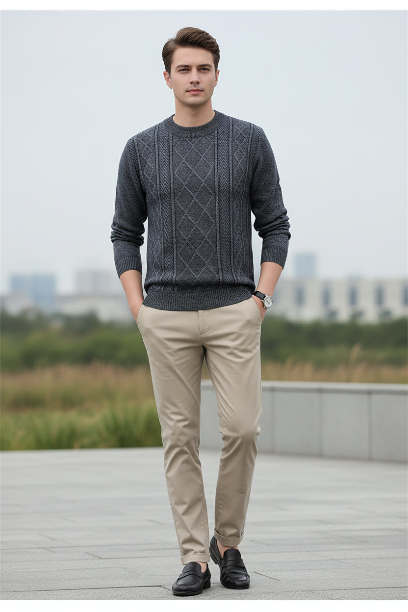 Person wearing a patterned gray sweater against a dark background