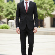 Black suit with a red patterned tie on a mannequin, paired with brown shoes on a white background.